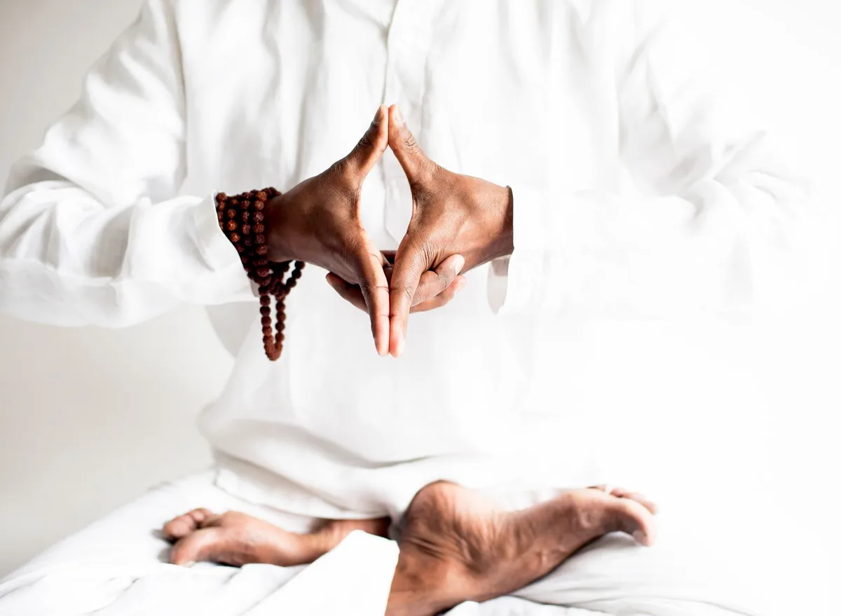 A peaceful yoga practice focused on meditation and balance, captured in serene white tones.